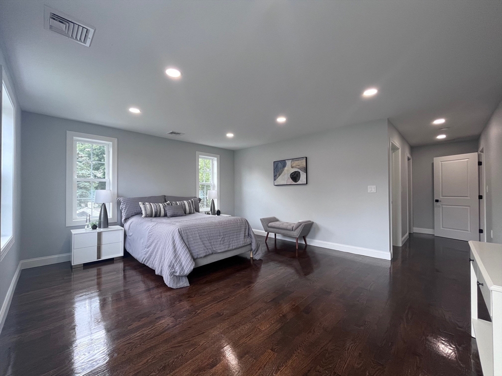 79 Holmes Road Dedham, MA 02026 - Photo 20 of 42 a spacious bedroom with a bed and a couch