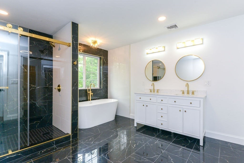 79 Holmes Road Dedham, MA 02026 - Photo 24 of 42 a spacious bathroom with a double vanity sink a mirror and a shower