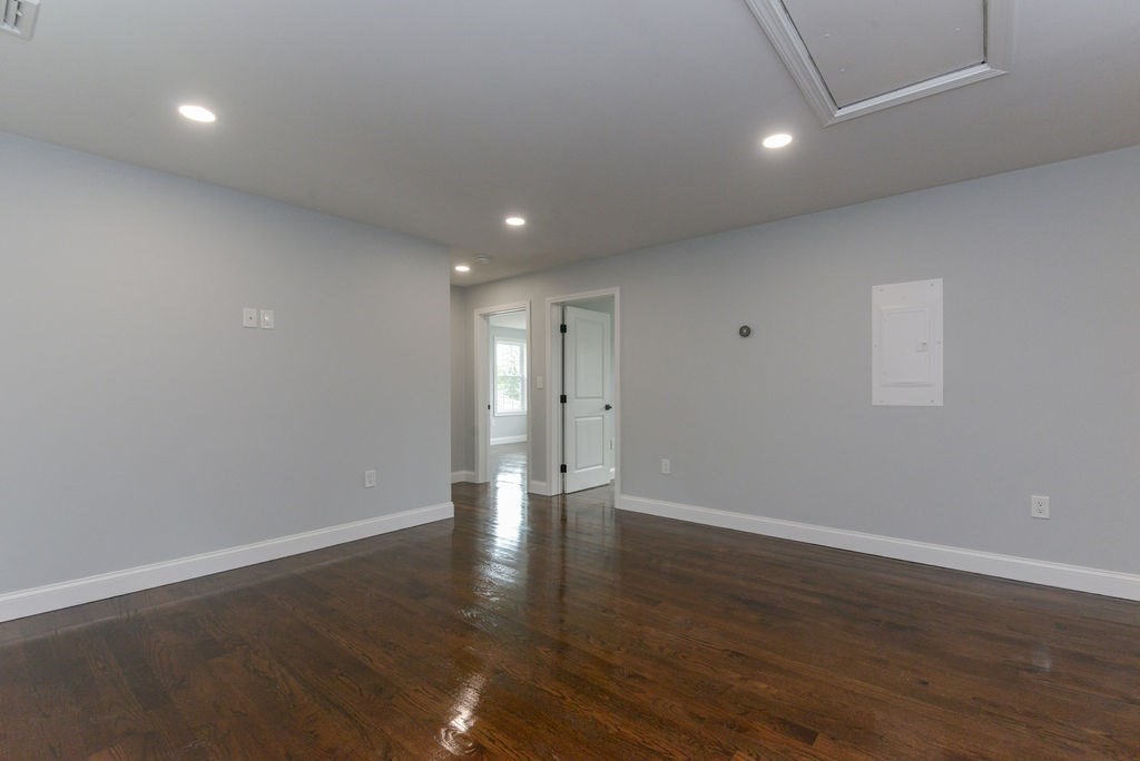 79 Holmes Road Dedham, MA 02026 - Photo 30 of 42 a view of an empty room with wooden floor