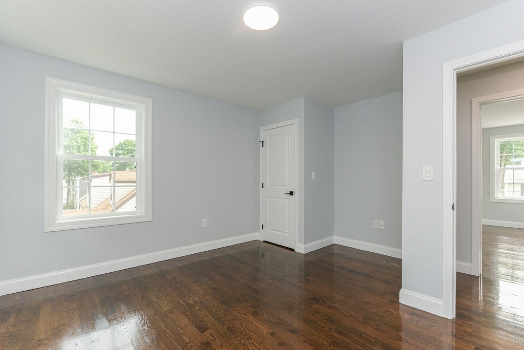 79 Holmes Road Dedham, MA 02026 - Photo 33 of 42 an empty room with wooden floor and windows