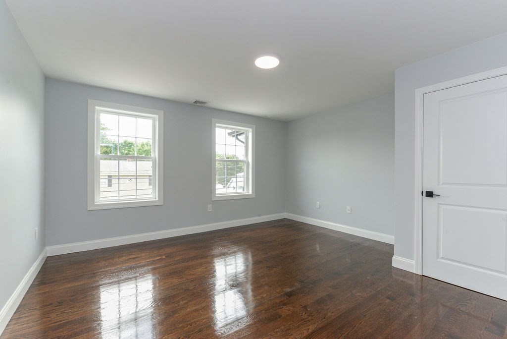 79 Holmes Road Dedham, MA 02026 - Photo 35 of 42 a view of an empty room with wooden floor and a window