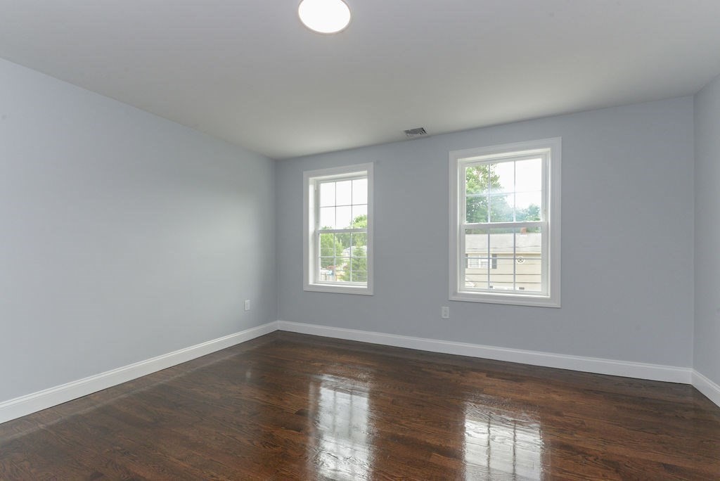 79 Holmes Road Dedham, MA 02026 - Photo 36 of 42 an empty room with wooden floor and windows