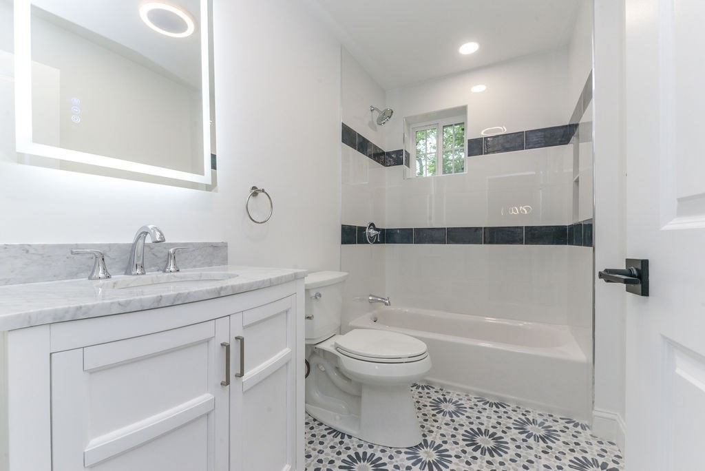 79 Holmes Road Dedham, MA 02026 - Photo 37 of 42 a bathroom with a granite countertop sink a toilet and bathtub