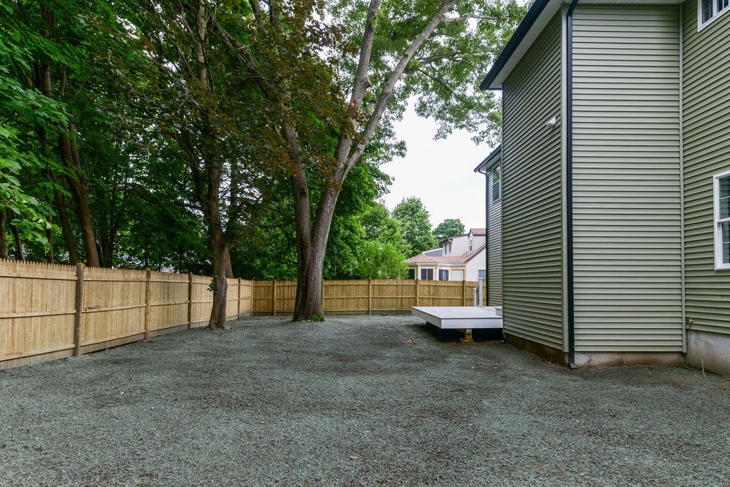 79 Holmes Road Dedham, MA 02026 - Photo 42 of 42 a view of a backyard with large trees