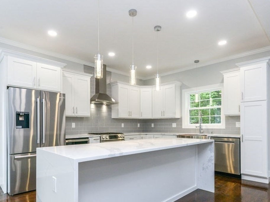 79 Holmes Road Dedham, MA 02026 - Photo 8 of 42 a kitchen with stainless steel appliances a sink stove and refrigerator