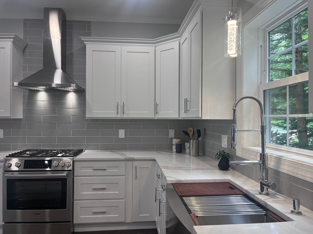 79 Holmes Road Dedham, MA 02026 - Photo 10 of 42 a kitchen with granite countertop a stove and a sink