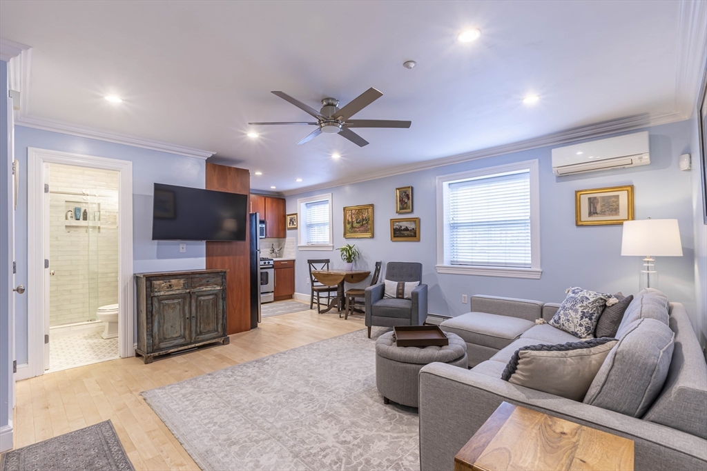 52 Cooper Street, Unit 2 Boston, MA 02113 - Photo 5 of 15 a living room with fireplace furniture and a flat screen tv