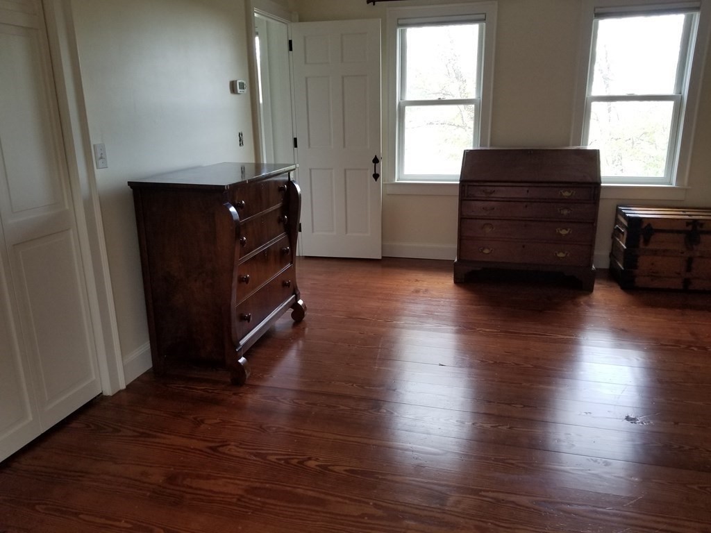 1125 N Road Hardwick, MA 01037 - Photo 37 of 41 an empty room with wooden floor and window