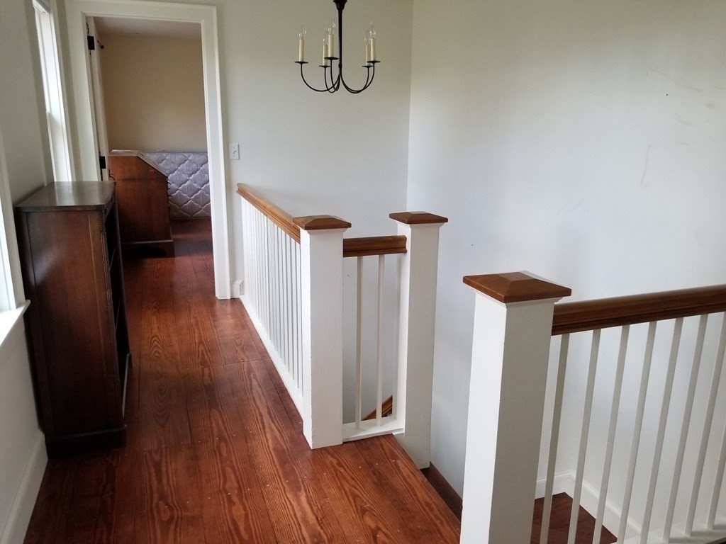 1125 N Road Hardwick, MA 01037 - Photo 39 of 41 a view of a hallway with wooden floor and stairs