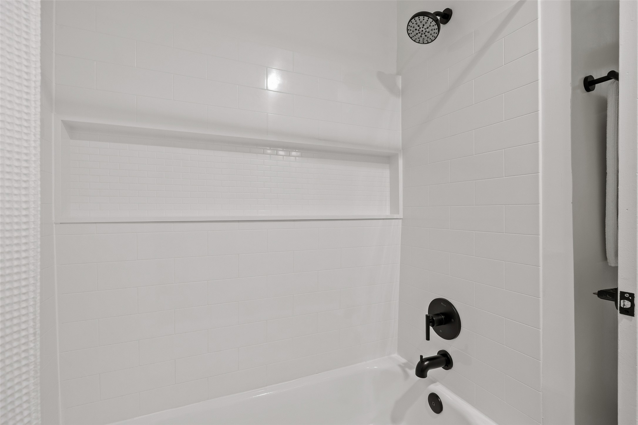 5506 South Pleasant Valley Road Austin, TX 78744 - Photo 12 of 25 A pristine white subway tile shower and tub combination provides a refreshing, clean aesthetic.