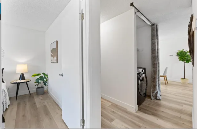 a view of hallway with furniture and wooden floor