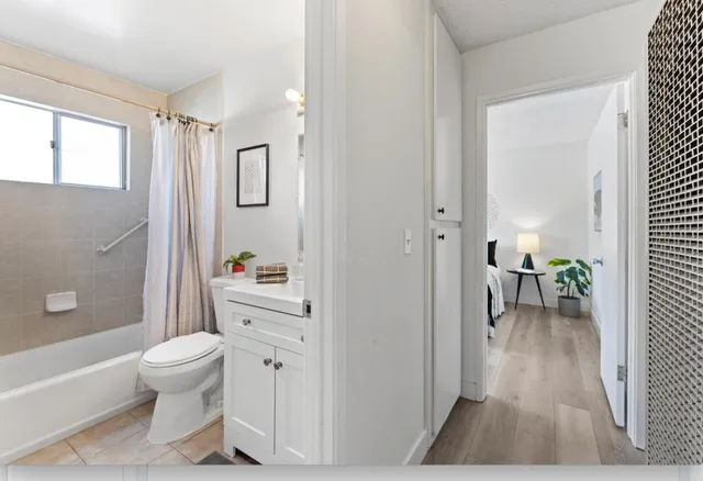 a spacious bathroom with a toilet a sink and a shower