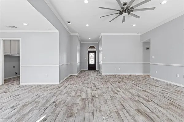 wooden floor in an empty room with a window