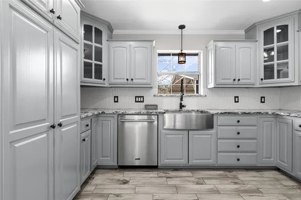 a kitchen with stainless steel appliances granite countertop a sink and cabinets