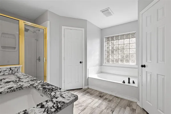 a bathroom with a bathtub and a shower