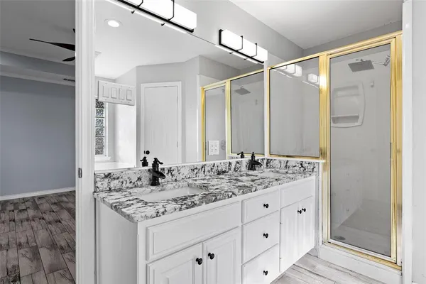 a bathroom with a granite countertop sink and a mirror