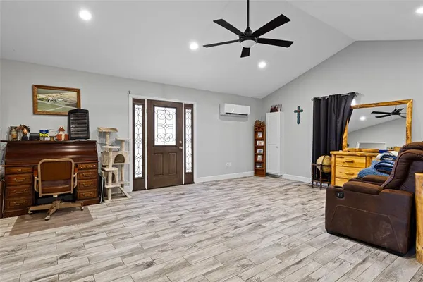 a bedroom with furniture and wooden floor