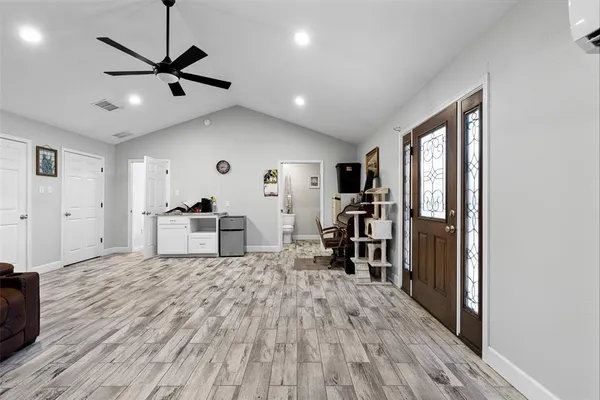 a view of kitchen and living room with wooden floor