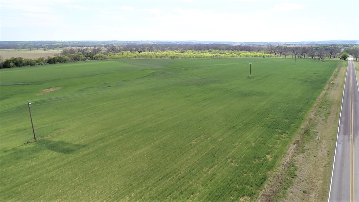 a view of a green field with clear sky