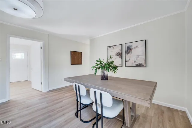 a dining room with furniture and wooden floor