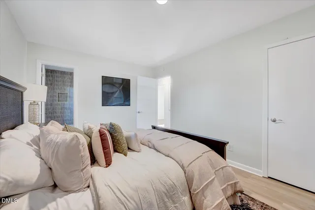 a bedroom with a bed and a painting on the wall