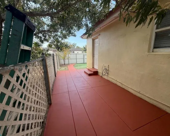 a backyard of a house with table and chairs