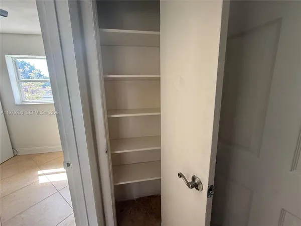 a view of walk in closet with empty racks