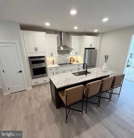 a kitchen with a table chairs refrigerator and cabinets
