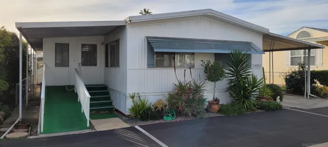 a front view of a house with plants