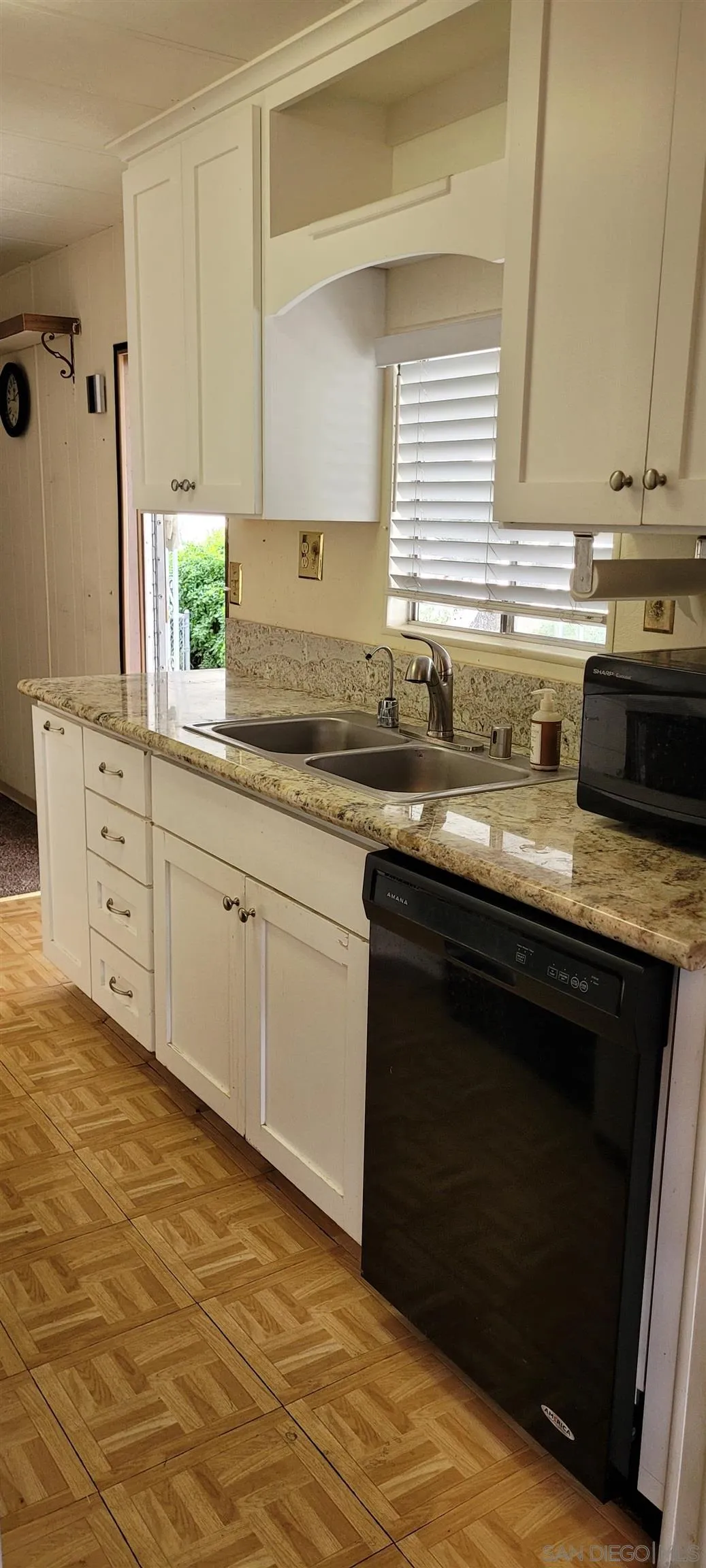 14004 Jasmine Avenue, Unit 260 Poway, CA 92064 - Photo 3 of 6 a kitchen with stainless steel appliances granite countertop a stove a sink and a microwave