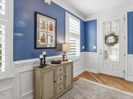 a living room with furniture a flat screen tv and a large window