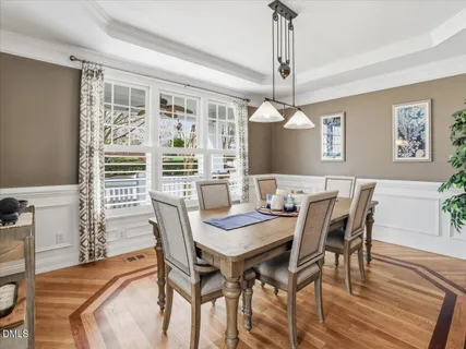 a view of a dining room with furniture window and wooden floor