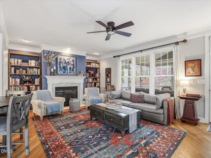 a kitchen with stainless steel appliances granite countertop a table chairs stove and cabinets