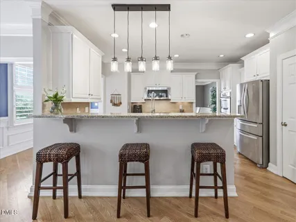 a bathroom with a granite countertop toilet a sink and mirror