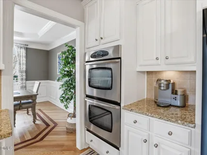 a bathroom with a granite countertop sink a toilet and a mirror