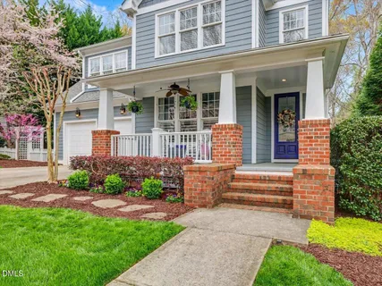 a front view of a house with garden and porch