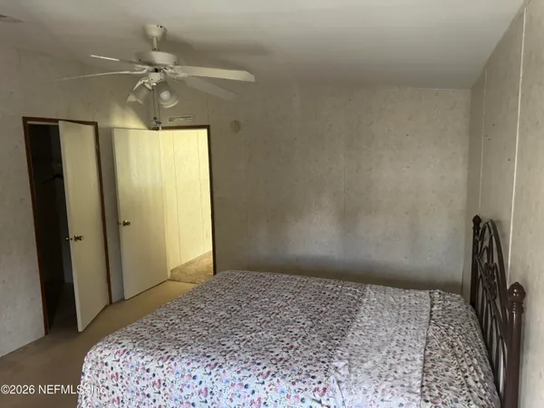 a bedroom with a bed and a chandelier