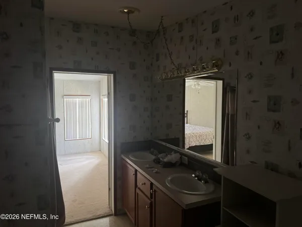 a bathroom with a sink a toilet and mirror