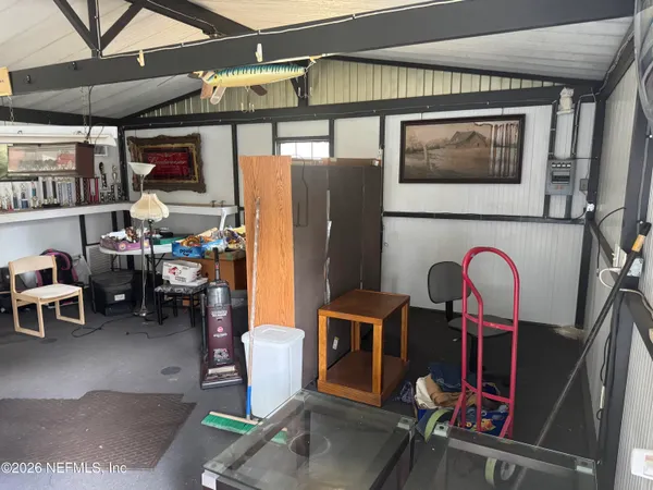 a living room with furniture a rug and white walls