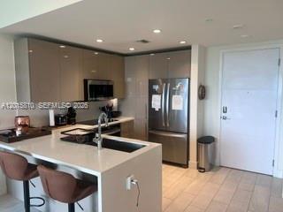 2000 Metropica Way, Unit 1902 Sunrise, FL 33323 - Photo 1 of 7 a kitchen with a sink cabinets and stainless steel appliances