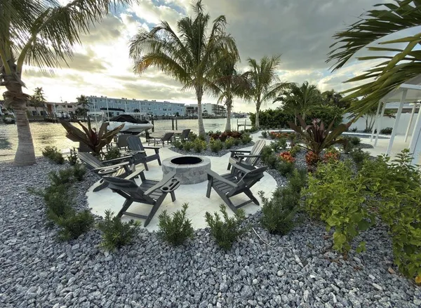 a view of a terrace with furniture and a garden