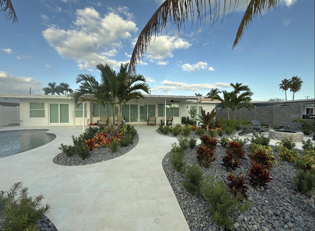 12350 4th Street East Treasure Island, FL 33706 - Photo 13 of 16 a front view of a house with a yard and potted plants
