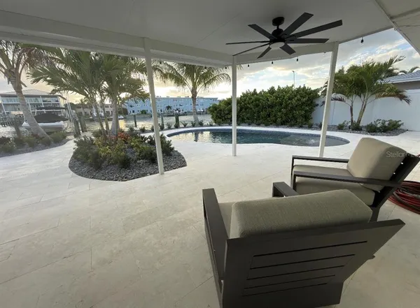 a building outdoor space with patio furniture and potted plants