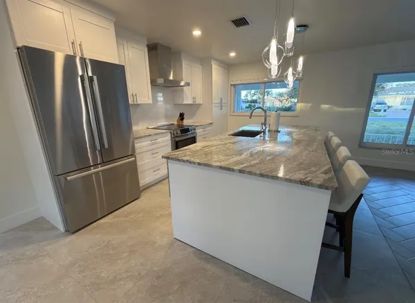 a room with pool table and windows