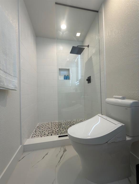 12350 4th Street East Treasure Island, FL 33706 - Photo 7 of 16 a bathroom with a toilet and a shower