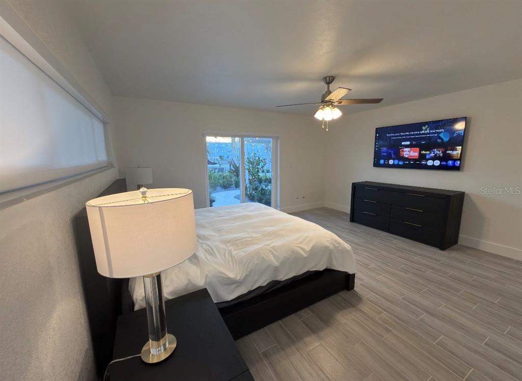 12350 4th Street East Treasure Island, FL 33706 - Photo 8 of 16 a bed room with furniture and a flat screen tv