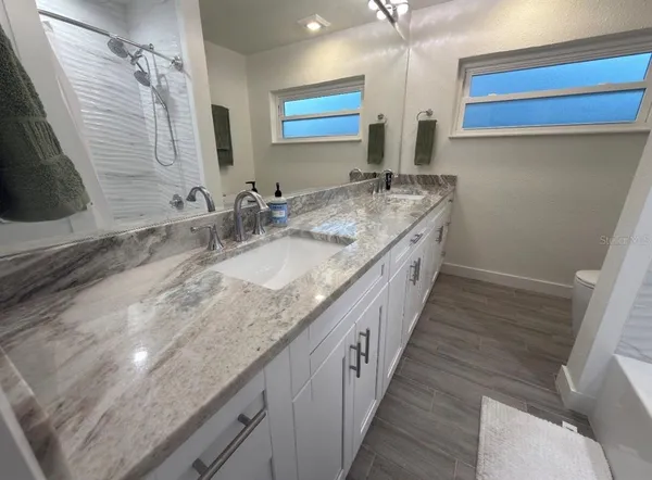 a bedroom with two beds and a chandelier