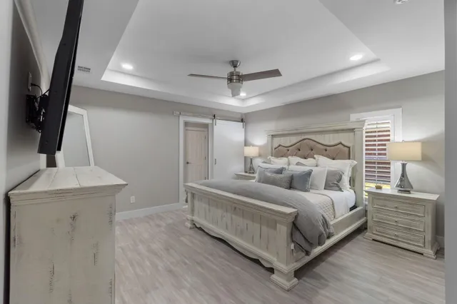 a bedroom with a bed and a night stand