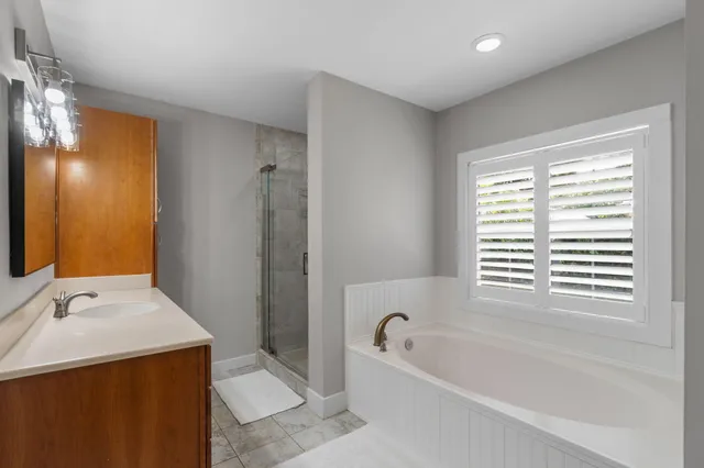 a bathroom with a bathtub and a shower