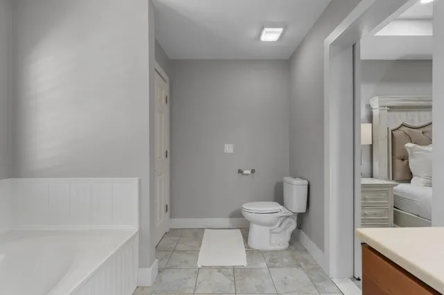 a bathroom with a toilet and a bathtub